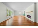 Spacious living room with hardwood floors, large windows, and a stylish fireplace for a cozy atmosphere at 5160 N High School Rd, Indianapolis, IN 46254