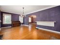 Hardwood floors and an arched doorway accent this room, bathed in natural light from large windows at 521 Kessler Blvd E Dr, Indianapolis, IN 46220