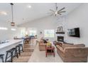 Open-concept living room with fireplace, large ceiling fan, and ample seating at 5304 Maywood Dr, Whitestown, IN 46075