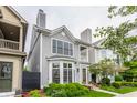 Charming two-story home with gray siding, bay window, front porch, and professionally landscaped yard at 626 N Senate Ave, Indianapolis, IN 46202