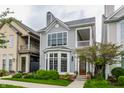 Charming two-story home with gray siding, bay window, front porch, and professionally landscaped yard at 626 N Senate Ave, Indianapolis, IN 46202