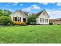 Charming two-story home with manicured lawn, white painted brick, stone accents and beautiful landscaping at 6672 Braemar S Ave, Noblesville, IN 46062