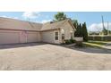 View of the home with a driveway, two-car garage, well-kept lawn, and some privacy fence at 6711 Bridgefield Way, Indianapolis, IN 46254