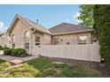 Inviting home with a decorative front yard, partial fence, and charming curb appeal at 6711 Bridgefield Way, Indianapolis, IN 46254