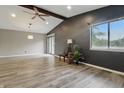Spacious living room with vaulted ceilings, fan, and large windows at 7940 Sunfield Ct, Indianapolis, IN 46214