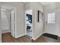 Inviting entryway with wood floors leading to a bedroom and white front door at 8820 Alexander Ridge Dr, McCordsville, IN 46055