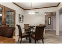 Cozy dining area with glass top table, wicker chairs, light fixture, and french doors to the outside at 8905 Washington Blvd West Dr, Indianapolis, IN 46240