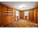 Cozy bedroom with wood-paneled walls, carpet flooring, and natural light at 924 N Devon Ave, Indianapolis, IN 46219