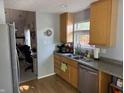 Functional kitchen with stainless steel appliances, wood cabinets, and updated fixtures at 9507 Colony Pointe E Dr, Indianapolis, IN 46250
