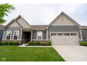Inviting single-story home with manicured lawn, garden beds and a convenient two-car garage at 9741 Haughton Ln, McCordsville, IN 46055