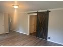 View of the Living Room with hard surface floors and stylish barn door at 988 Westfield Rd, Noblesville, IN 46062