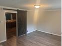 View of the Living Room and doorway to Kitchen area with stylish barn door and hard surface flooring at 988 Westfield Rd, Noblesville, IN 46062