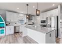 Bright and airy kitchen featuring white cabinets, stainless steel appliances, and granite countertops at 9917 Gallop Ln, Fishers, IN 46040