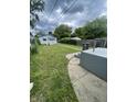 Spacious backyard featuring a concrete platform, grassy area, and some trees at 1021 W 37Th St, Indianapolis, IN 46208