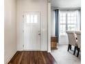 Bright foyer with hardwood floors and a view into the dining area with large windows, creating an inviting entrance at 1065 Park Ct, Avon, IN 46123