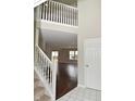 Bright foyer with staircase leading to upper level and a view of the living area at 10722 Mistflower Way, Indianapolis, IN 46235