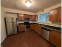 Modern kitchen featuring stainless steel appliances and wood cabinets at 10722 Mistflower Way, Indianapolis, IN 46235