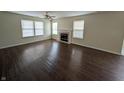 Spacious living room boasts hardwood floors, a cozy fireplace, and ample natural light at 10722 Mistflower Way, Indianapolis, IN 46235