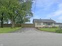 View of the front yard with a driveway leading to a single story home at 108 N A St, Elwood, IN 46036