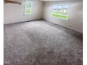 Spacious living room featuring neutral carpeting and ample natural light at 108 N A St, Elwood, IN 46036