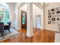 Spacious foyer with hardwood floors, featuring decorative columns and views into the dining room and living area at 11911 W Grandview Dr, Columbus, IN 47201