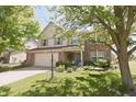 Beautiful exterior view of a two-story home with a well-maintained lawn and mature trees at 12677 Honors Dr, Carmel, IN 46033