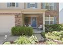 Inviting front porch with blue door, stylish seating, and charming landscaping at 12677 Honors Dr, Carmel, IN 46033