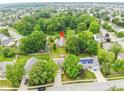 Beautiful aerial view of a home nestled amongst lush trees in a well-maintained residential neighborhood at 13911 Naples Dr, Fishers, IN 46038