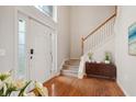 Inviting foyer featuring wood floors, staircase, and elegant decor at 14036 Rayners Ln, Fishers, IN 46037