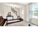 Inviting foyer features staircase, chandelier, and decorative accents at 14499 Milton Rd, Fishers, IN 46037