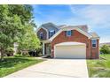 Charming two-story home with a brick facade and well-manicured lawn at 14499 Milton Rd, Fishers, IN 46037