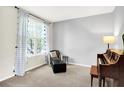 Cozy living room with a chair, ottoman, and window at 14499 Milton Rd, Fishers, IN 46037
