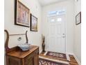Inviting foyer with a decorative wood table, rug, and white front door at 1468 Blackthorne N Trl, Plainfield, IN 46168