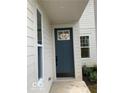 Inviting entrance with a stylish navy blue front door, side lights and crisp white trim at 17399 Dovehouse Ln, Westfield, IN 46074
