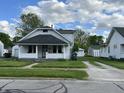 Quaint two-story home with a covered porch and well-kept front lawn at 207 E Plum St, Anderson, IN 46012