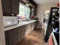 Cozy kitchen featuring plenty of counter space and cabinets with black appliances at 207 E Plum St, Anderson, IN 46012