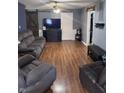Inviting living room with cozy gray seating, wood floors, and a sliding barn door at 2208 S F St, Elwood, IN 46036