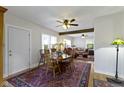 Cozy dining room featuring hardwood floors, a ceiling fan, and an adjacent living area at 236 W 33Rd St, Indianapolis, IN 46208