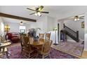 Elegant dining room with a wooden table, chairs, and hardwood floors, open to the living room at 236 W 33Rd St, Indianapolis, IN 46208