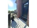Inviting porch with brick detail, Happy Hour mat, and potted plants that add to the home's cozy appeal at 247 Poplar St, Westfield, IN 46074