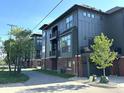 Row of well-maintained modern townhouses with attached garages and balconies along a paved street at 247 Poplar St, Westfield, IN 46074