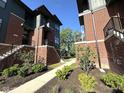 View of modern townhouses showing well-manicured landscaping, sidewalks, and classic brick and siding design at 247 Poplar St, Westfield, IN 46074
