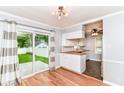 Eat-in kitchen with wood floors, white cabinets, butcher block countertops and stainless steel appliances at 2526 Dell Zell Dr, Indianapolis, IN 46220