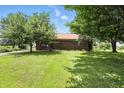 Charming single story home with a brick exterior and surrounded by mature trees and a green lawn at 25420 Jerkwater Rd, Sheridan, IN 46069