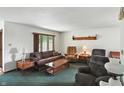 Bright living room with a carpet, a large window, lamps and cozy furniture at 25420 Jerkwater Rd, Sheridan, IN 46069