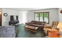 Cozy living room featuring carpeted flooring, a large window and comfortable seating arrangements at 25420 Jerkwater Rd, Sheridan, IN 46069