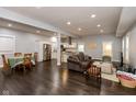 Expansive open-concept living space flows seamlessly into the kitchen, featuring dark hardwood floors and modern decor at 326 Parkway Ave, Indianapolis, IN 46225