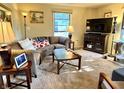 Comfortable living room features stylish furniture, plush carpeting, and natural light from large windows at 3321 Sycamore Dr, Columbus, IN 47203