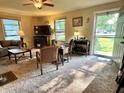 Inviting living room featuring a large window and neutral carpeting with a view to the home's entrance at 3321 Sycamore Dr, Columbus, IN 47203