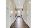 Bright hallway featuring laminate flooring, white doors, neutral walls and decorative art at 3786 Cantebury Dr, Franklin, IN 46131